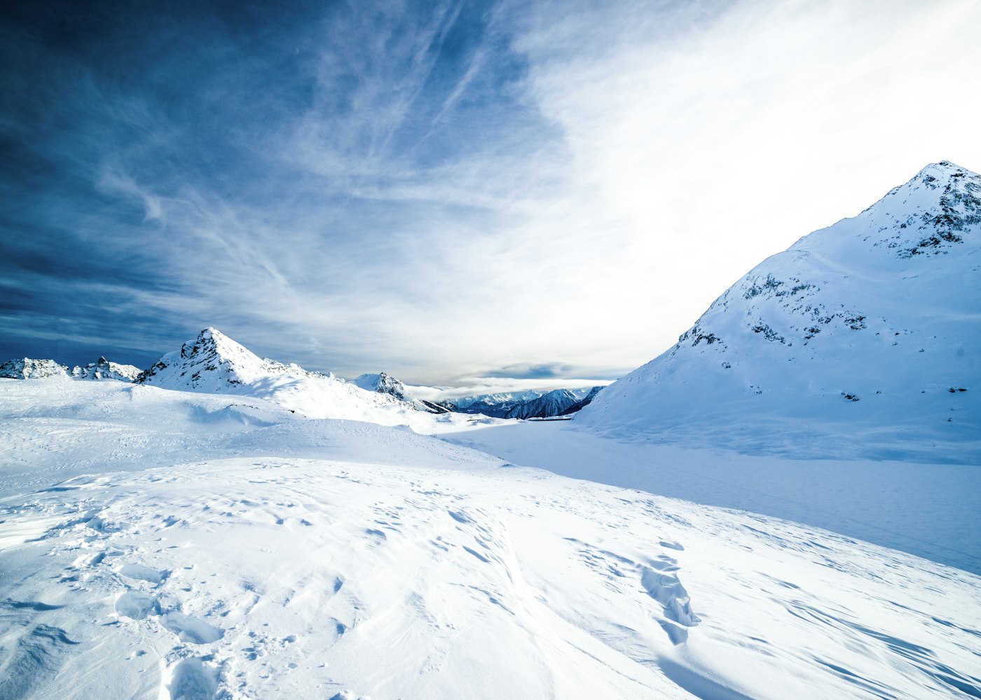 Trekkers below a blue glacier